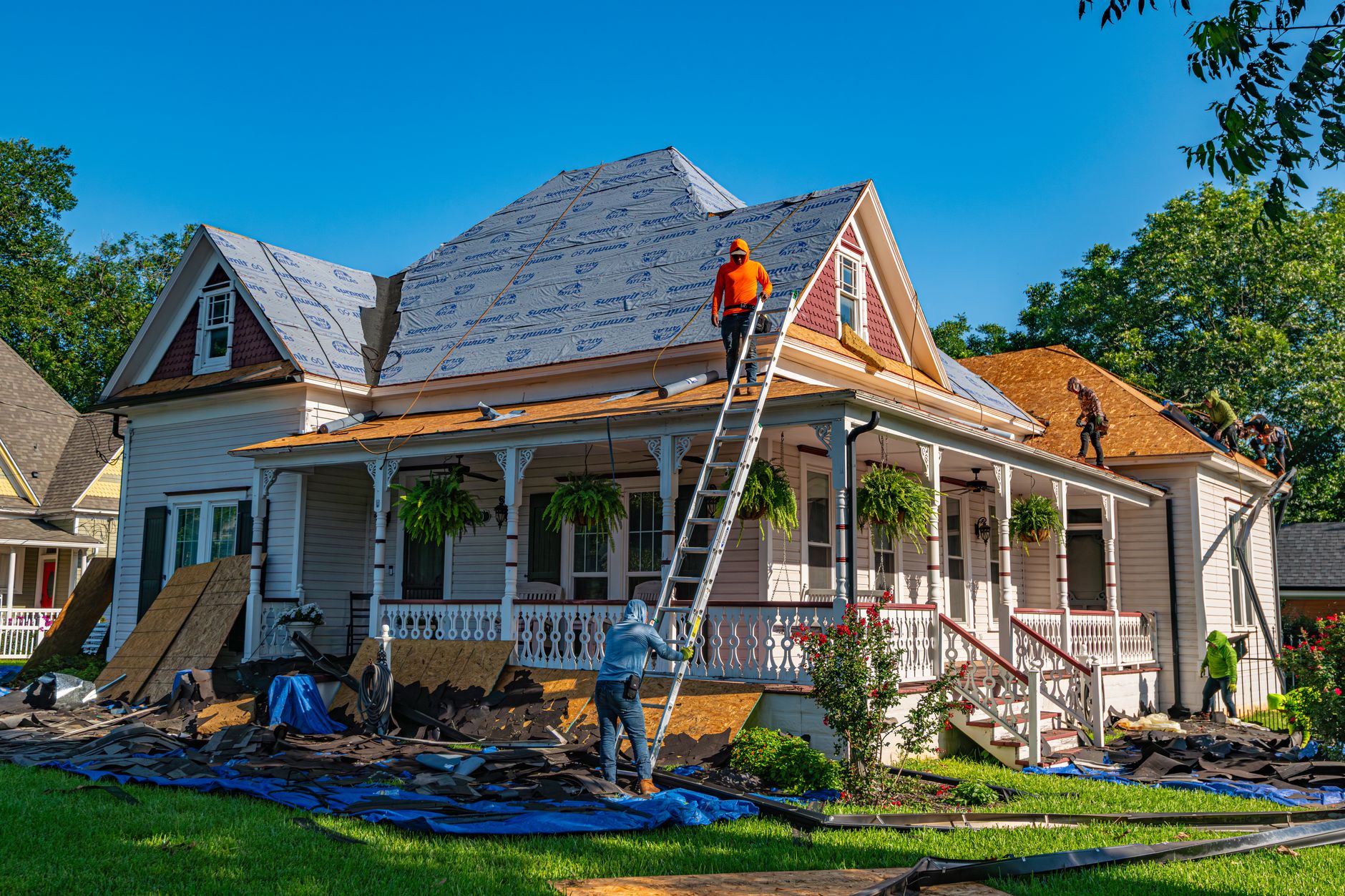 Roofers replacing shingles on a residential roof